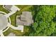 Aerial view of a house with a complex roofline surrounded by a yard and green trees at 16244 Perrault Ct, Fishers, IN 46040