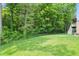 Lush backyard with a black fence bordering mature trees, creating a private and serene outdoor space at 16244 Perrault Ct, Fishers, IN 46040