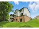 Spacious backyard view of the house with a covered deck and lush lawn, ideal for outdoor enjoyment and entertaining at 16244 Perrault Ct, Fishers, IN 46040