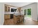 Modern bar area boasts light wood cabinets, black countertops, marble backsplash, and beverage refrigerators at 16244 Perrault Ct, Fishers, IN 46040