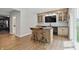 Modern bar area boasts light wood cabinets, black countertops, marble backsplash, and beverage refrigerators at 16244 Perrault Ct, Fishers, IN 46040