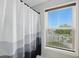 Bathroom featuring a patterned shower curtain and window with blinds overlooking a street at 16244 Perrault Ct, Fishers, IN 46040