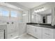 Modern bathroom with a glass-enclosed shower, double vanity, and sleek black countertops at 16244 Perrault Ct, Fishers, IN 46040