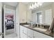 Bright bathroom featuring dual sinks, modern vanity and marble tile flooring at 16244 Perrault Ct, Fishers, IN 46040