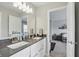 Bright bathroom with dual sinks, modern vanity and view into the bedroom at 16244 Perrault Ct, Fishers, IN 46040