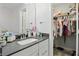 Bathroom with a gray countertop vanity and mirror, plus a walk-in closet at 16244 Perrault Ct, Fishers, IN 46040
