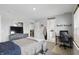 Neutral bedroom featuring a queen-sized bed, a desk with gaming chair and natural light at 16244 Perrault Ct, Fishers, IN 46040