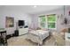 Cozy bedroom with a white metal frame bed, large window, and playful decor at 16244 Perrault Ct, Fishers, IN 46040