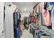 Walk-in closet with organized hanging space for clothes, and shelving for other accessories at 16244 Perrault Ct, Fishers, IN 46040