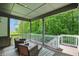 Covered deck with comfortable wicker seating, offering a relaxing outdoor space with views of the lush backyard at 16244 Perrault Ct, Fishers, IN 46040
