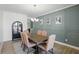 Elegant dining room with wainscotting, stylish chandelier, and seating for six at 16244 Perrault Ct, Fishers, IN 46040