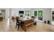 Dining area featuring an rustic table with a bench, and view to the living room and backyard at 16244 Perrault Ct, Fishers, IN 46040