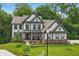 Beautiful two-story home featuring manicured lawn and charming architectural details and covered front porch at 16244 Perrault Ct, Fishers, IN 46040