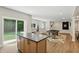 Large recreation room with a pool table, island with stools, and sliding glass doors to backyard at 16244 Perrault Ct, Fishers, IN 46040