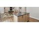 Stylish island with gray countertop and wood cabinets in a recreation room at 16244 Perrault Ct, Fishers, IN 46040
