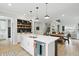 Open kitchen with a large island, stainless steel appliances, and an adjacent dining and living area at 16244 Perrault Ct, Fishers, IN 46040