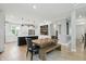 Modern kitchen with white cabinets, stainless steel appliances, and a large island, next to the dining area at 16244 Perrault Ct, Fishers, IN 46040