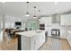 Spacious kitchen features a large island, stainless steel appliances, and an open layout to the dining and living areas at 16244 Perrault Ct, Fishers, IN 46040