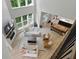 Open-concept living space with fireplace, view of kitchen, and large windows at 16244 Perrault Ct, Fishers, IN 46040