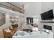 Open-concept living room with fireplace, high ceilings, and staircase at 16244 Perrault Ct, Fishers, IN 46040