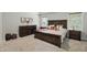 Serene main bedroom with a wooden bed, soft lighting, and ample natural light through bright windows at 16244 Perrault Ct, Fishers, IN 46040