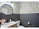Charming half-bathroom with modern fixtures and patterned wallpaper at 16244 Perrault Ct, Fishers, IN 46040