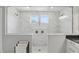 Beautiful walk-in shower with marble tiling, dual shower heads, and bright natural light at 16244 Perrault Ct, Fishers, IN 46040