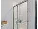 Modern shower featuring glass sliding doors, built-in shelving, and a clean design at 16244 Perrault Ct, Fishers, IN 46040