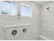 Close-up of walk-in shower featuring marble tile, built-in bench, and dual shower heads at 16244 Perrault Ct, Fishers, IN 46040