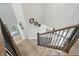 Bright staircase featuring carpeted steps and decorative wall accents leading to an open floor plan at 16244 Perrault Ct, Fishers, IN 46040