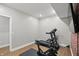 Home workout room featuring a treadmill, exercise bike, and TV at 16244 Perrault Ct, Fishers, IN 46040