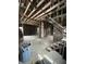 This interior space shows stairs with exposed framing and a trash can at 1630 E 18Th St, Indianapolis, IN 46218