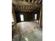 Awaiting restoration, the expansive living room features exposed framing, bright windows, and a blank canvas for your design vision at 1630 E 18Th St, Indianapolis, IN 46218