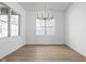 Well lit dining room featuring hardwood floors, a modern chandelier, and large windows at 1655 Fernley Dr, Westfield, IN 46074