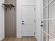 Welcoming entryway with a white door and stylish coat rack, blending functionality and modern design at 1655 Fernley Dr, Westfield, IN 46074