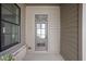 Charming front porch featuring natural wood siding, brick accents, and a gray-painted door at 1655 Fernley Dr, Westfield, IN 46074