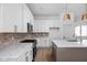 Modern kitchen with white cabinets, marble countertops, and stainless steel appliances at 1655 Fernley Dr, Westfield, IN 46074