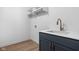 Laundry room with a sink, quartz countertop, brass faucet, and blue cabinets at 1655 Fernley Dr, Westfield, IN 46074