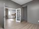 Office with hardwood floors and French doors leading to a kitchen with white cabinets and stainless appliances at 1655 Fernley Dr, Westfield, IN 46074