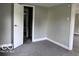 View of bedroom with neutral carpet, gray paint, open door and hall at 1720 E Cornell Ave, Muncie, IN 47303