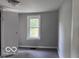 Bedroom featuring a window and neutral gray carpet, creating a cozy space at 1720 E Cornell Ave, Muncie, IN 47303