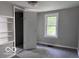 Bedroom with built-in shelving, window, and neutral carpet at 1720 E Cornell Ave, Muncie, IN 47303