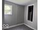 A quaint bedroom featuring a window, gray walls and carpeting at 1720 E Cornell Ave, Muncie, IN 47303