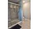 Tiled bathroom featuring glass enclosed shower and modern finishes at 17255 Seaboard Pl, Noblesville, IN 46060