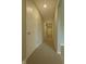 Long hallway with neutral carpeting and multiple paneled doors to bedrooms at 17255 Seaboard Pl, Noblesville, IN 46060