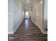 Inviting hallway featuring vinyl floors leading to a bright white front door at 17255 Seaboard Pl, Noblesville, IN 46060