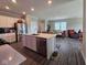 Open-concept kitchen with an island and stainless steel appliances overlooking the dining area at 17255 Seaboard Pl, Noblesville, IN 46060
