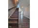 Carpeted staircase with wooden handrail and a view of the open floor plan at 17255 Seaboard Pl, Noblesville, IN 46060