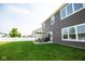Large backyard with green lawn, patio furniture, and privacy fence at 18297 Rickety Dr, Westfield, IN 46074