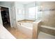 Bright bathroom with a soaking tub, tiled shower, and modern fixtures at 18297 Rickety Dr, Westfield, IN 46074
